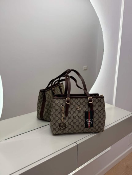 Gucci GG Supreme Tote bag on mirrored surface, elegant and functional design.
