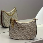 Michael Kors Hobo monogram cream bag with gold chain.