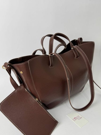 Brown leather university bag with contrast stitching and tag.