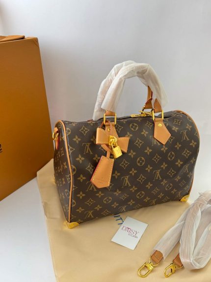 Louis Vuitton Speedy Bandoulière handbag with monogram design and gold accents.