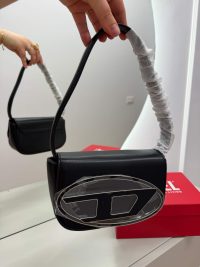 Elegant black Diesel handbag with logo and box.