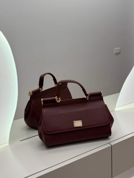 Dolce & Gabbana Sicily bordo handbag on mirrored surface.