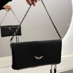 Zadig & Voltaire black clutch with chain strap and wing emblem.