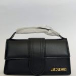 Black Jacquemus Le Bambino handbag with gold logo detailing.