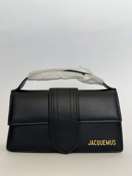 Black Jacquemus Le Bambino handbag with gold logo detailing.