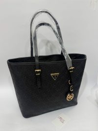 Black Guess monogram tote bag with gold accents.