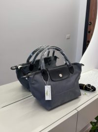 Longchamp Le Pliage bag, elegant gray design on display.
