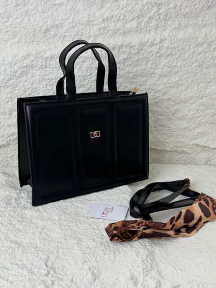Structured black tote bag with leopard scarf and strap.