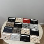 Guess unisex card holders displayed on a table, various colors.