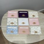 Colorful Coach cardholders displayed on a table.