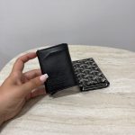 Hugo Boss cardholder with pop-up mechanism on marble table.