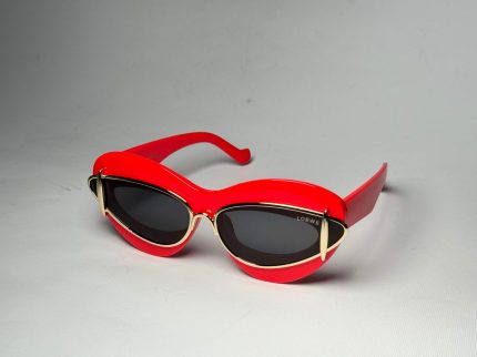 Red Loewe cat-eye sunglasses with gold accents on white background.