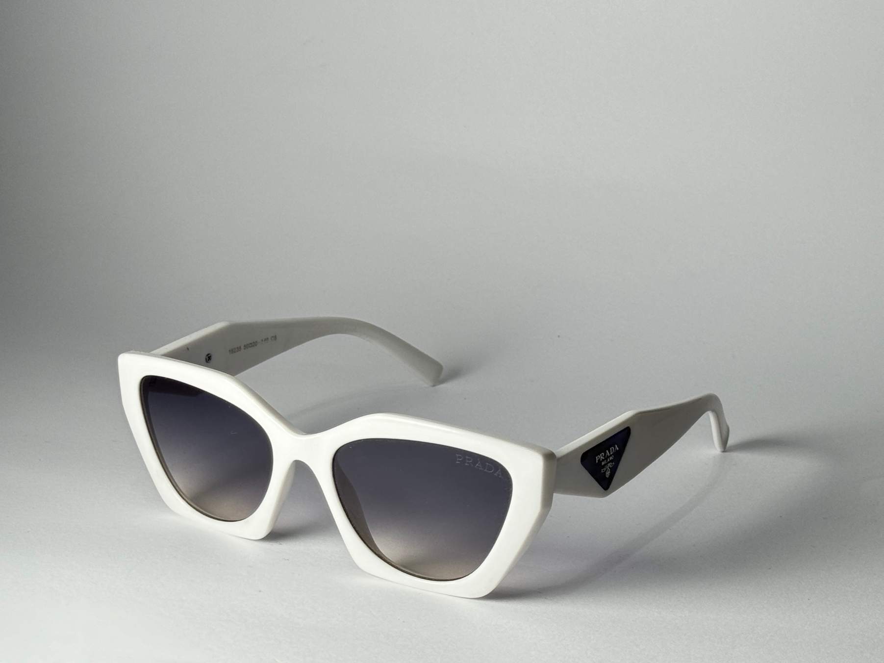 ds-syze-334-kryesore Prada white cat-eye sunglasses with gradient lenses.