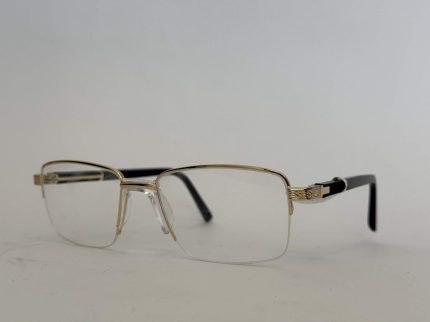 Skelete Optike për Meshkuj, gold rimmed eyeglasses with black temples.