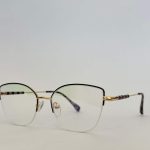 Elegant Skelete Optike Daisy glasses with gold accents and clear lenses.