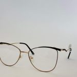 Skelete Optike Daisy Store stylish eyeglasses with gold and black frame.