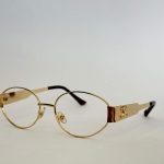 Gold women's optical glasses with round frames and sleek design.