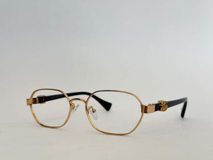 Gold Gucci women's eyeglasses with black temples on white background.
