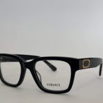 Elegant Versace women's black eyeglasses with gold accents.