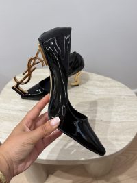 Black patent heels with gold YSL logo heel detail.