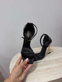 Black YSL Opyum sandals with straps and gold heel detail.