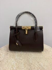 Dolce & Gabbana brown handbag with gold frame detail.