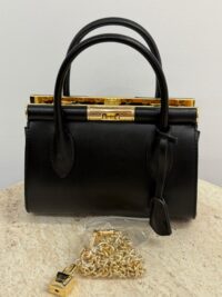 Dolce & Gabbana black handbag with gold frame and chain.
