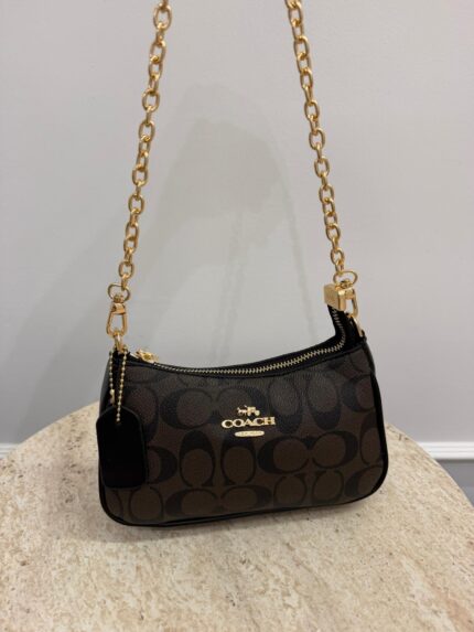 Coach Teri Shoulder Bag with chain, brown monogram design.