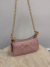 Pink Coach Teri Shoulder Bag with gold chain on display.