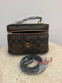 Coach Vanity Case with strap, elegant and practical design.