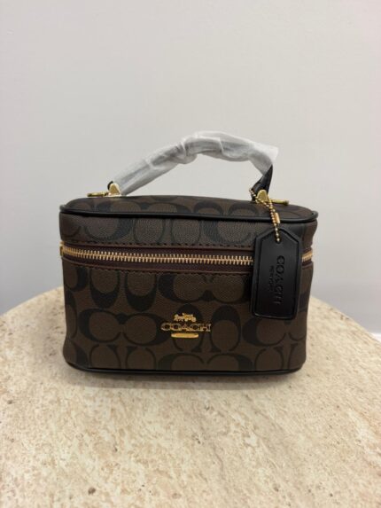 Coach Vanity Case with strap, elegant and practical design.