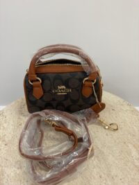 Coach Mini Barrel handbag with brown leather accents.