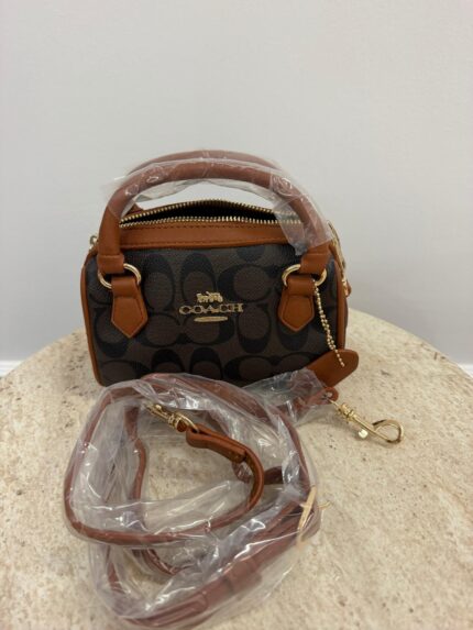 Coach Mini Barrel handbag with brown leather accents.