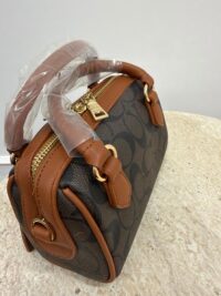 Coach Mini Barrel handbag with brown leather accents.