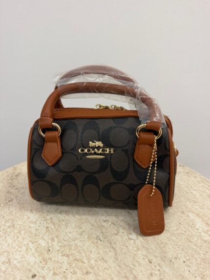 Coach Mini Barrel handbag with brown leather accents.
