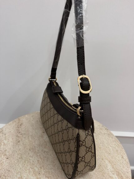 Gucci Aphrodite GG leather shoulder bag on display.