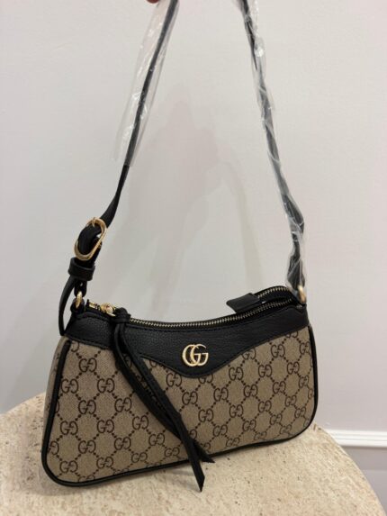 Gucci Aphrodite GG handbag with gold chain and logo pattern.