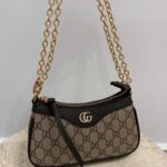 Gucci Aphrodite GG handbag with gold chain and logo pattern.