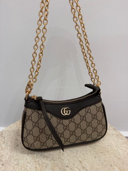 Gucci Aphrodite GG handbag with gold chain and logo pattern.