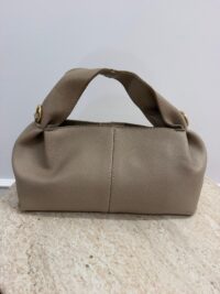 Beige Polène leather handbag on marble surface.