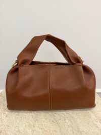 Brown leather Polène handbag on marble surface.