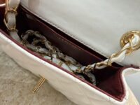 Chanel Mini Flap bag with gold chain detail and red interior.