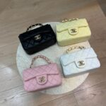 Chanel Mini Flap bags in black, yellow, pink, and white on display.