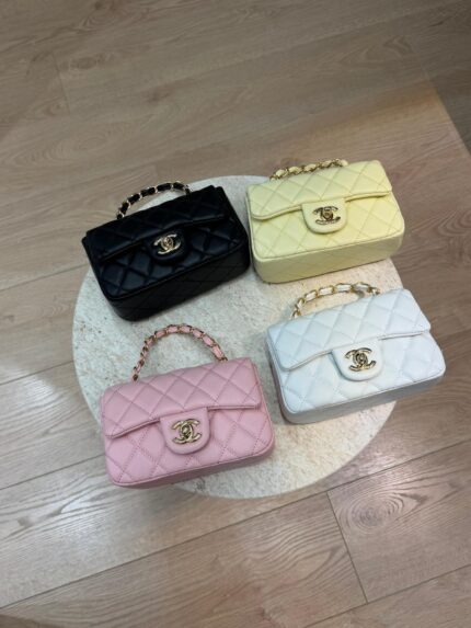 Chanel Mini Flap bags in black, yellow, pink, and white on display.