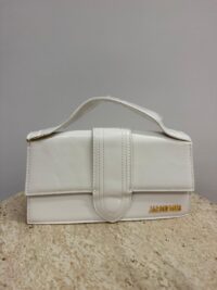 White Jacquemus Le Bambino Long handbag on marble surface.