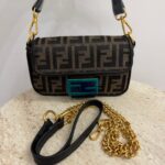 Fendi Baguette FF bag with gold chain and black strap.