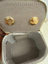 Chanel Vanity Mini bag interior with gold chain and logo details.
