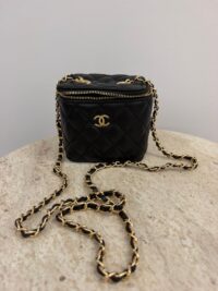 Chanel Vanity Mini black quilted bag with gold chain.