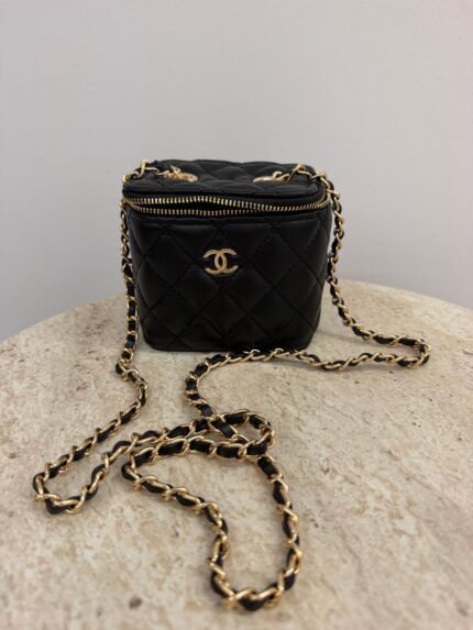 Chanel Vanity Mini black quilted bag with gold chain.