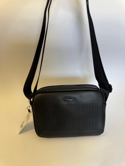 Black Lacoste bag with perforated front and shoulder strap.